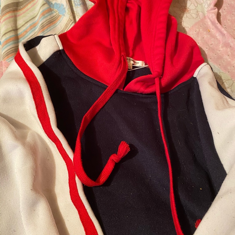 This is a red , white, and blue cropped sweater